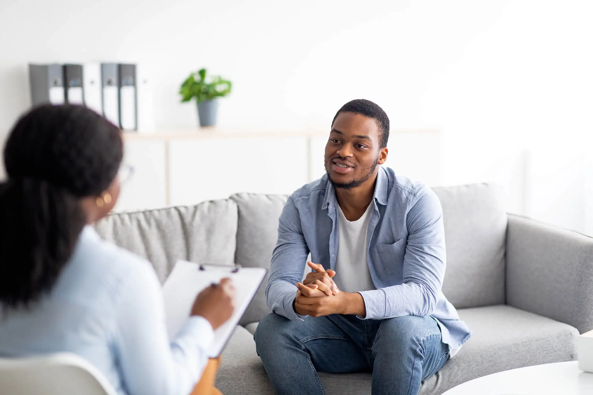 Man engaging with a therapist in a supportive environment for eating disorder recovery