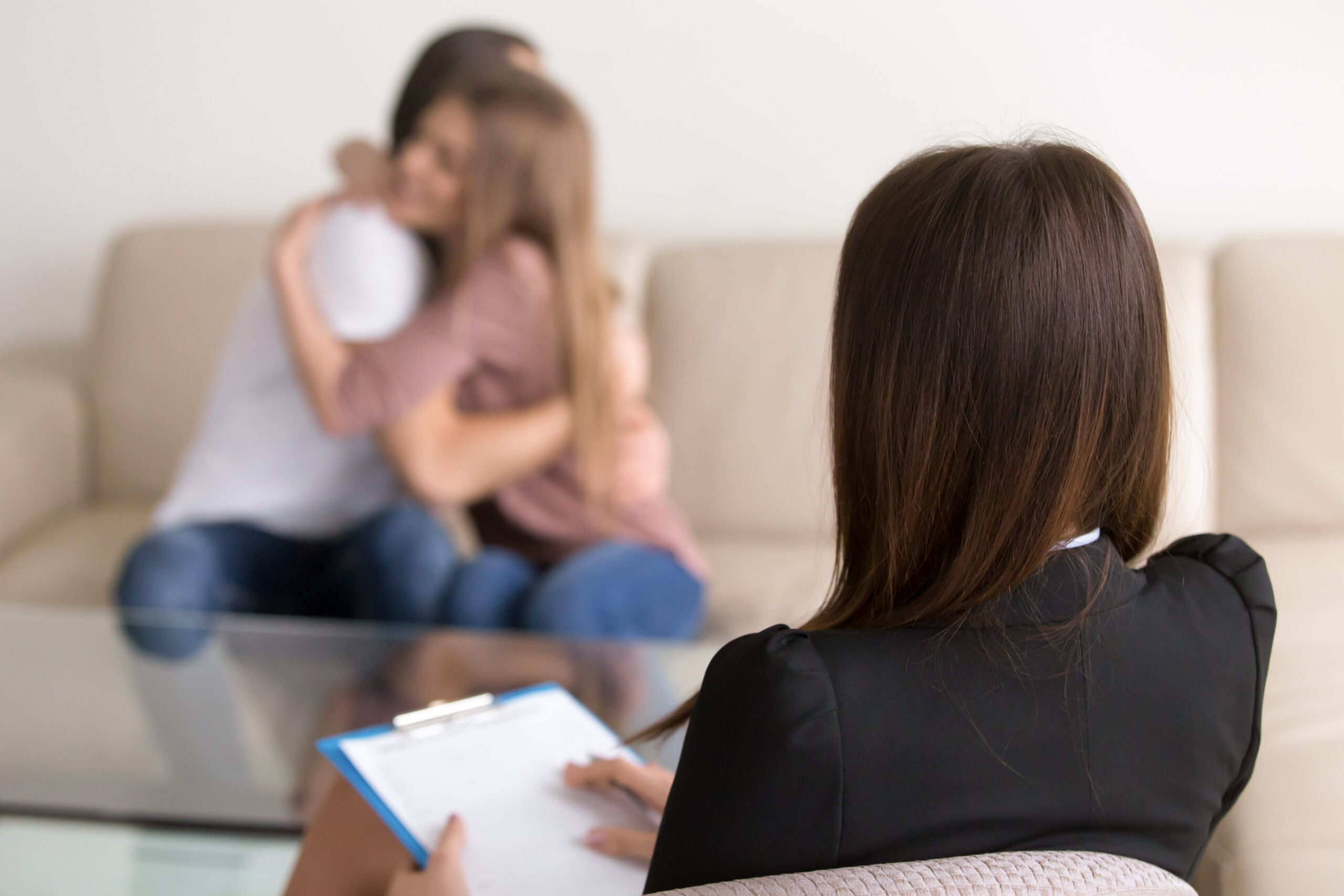 Female psychologist helps a young couple during a therapy session, focusing on relationship issues and eating disorder treatment