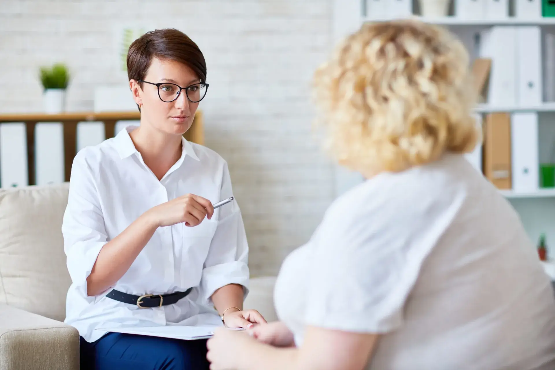 Therapist providing psychological consultation to a female patient